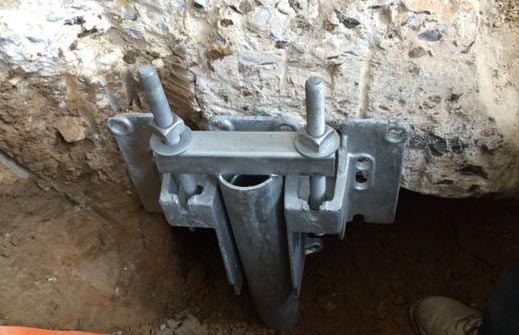 A micro pile foundation bracket installed at the base of a foundation