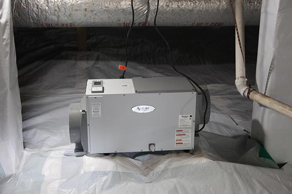 A crawl space with a dehumidifier installed